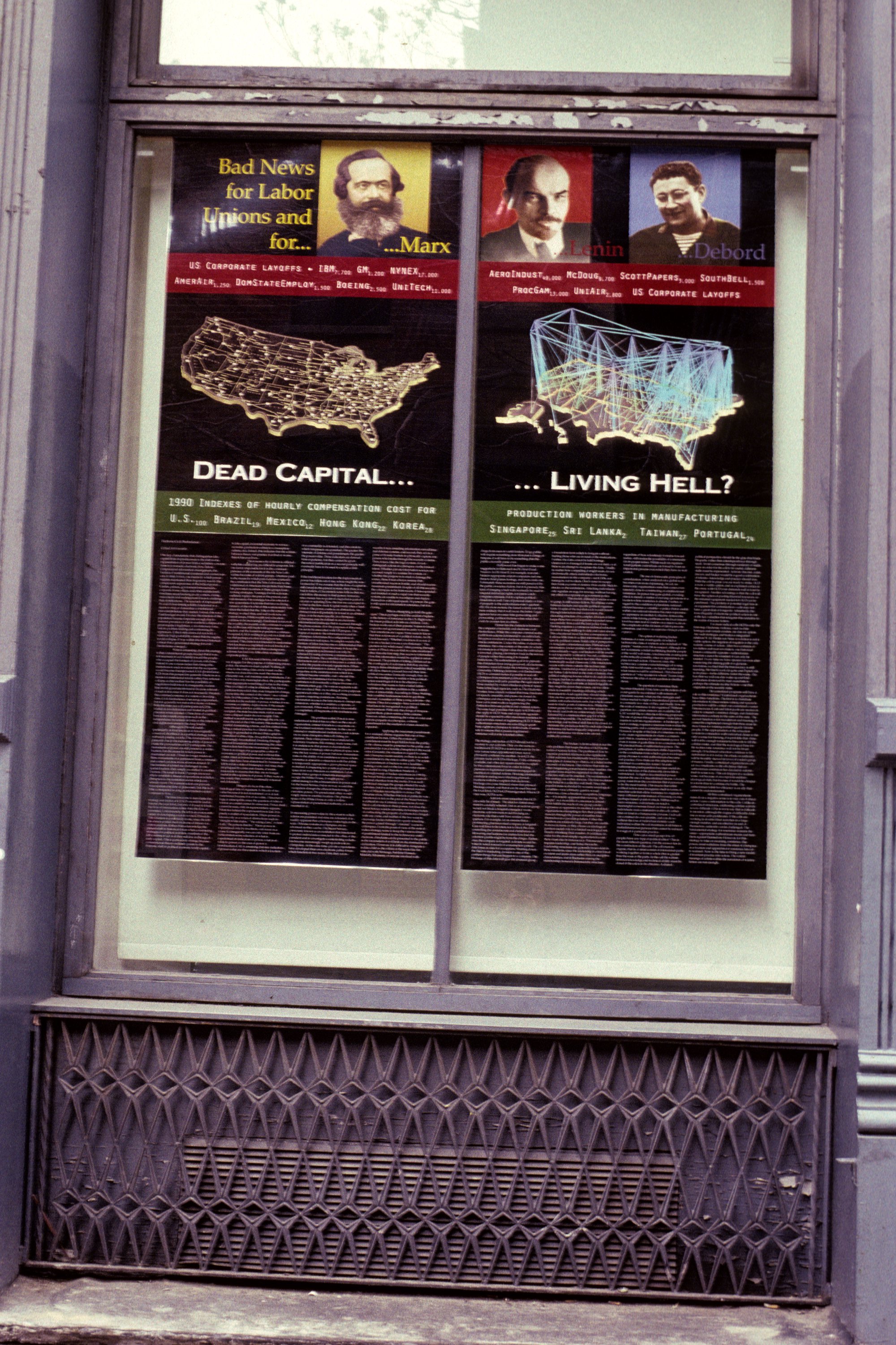 Two long black posters behind a columned window with Marx, Lenin, and Debord headshots at the top, a data visualized U.S. map, and small white print filling the bottom. A infographic that only those curious about anarchy would stop to read on the street.