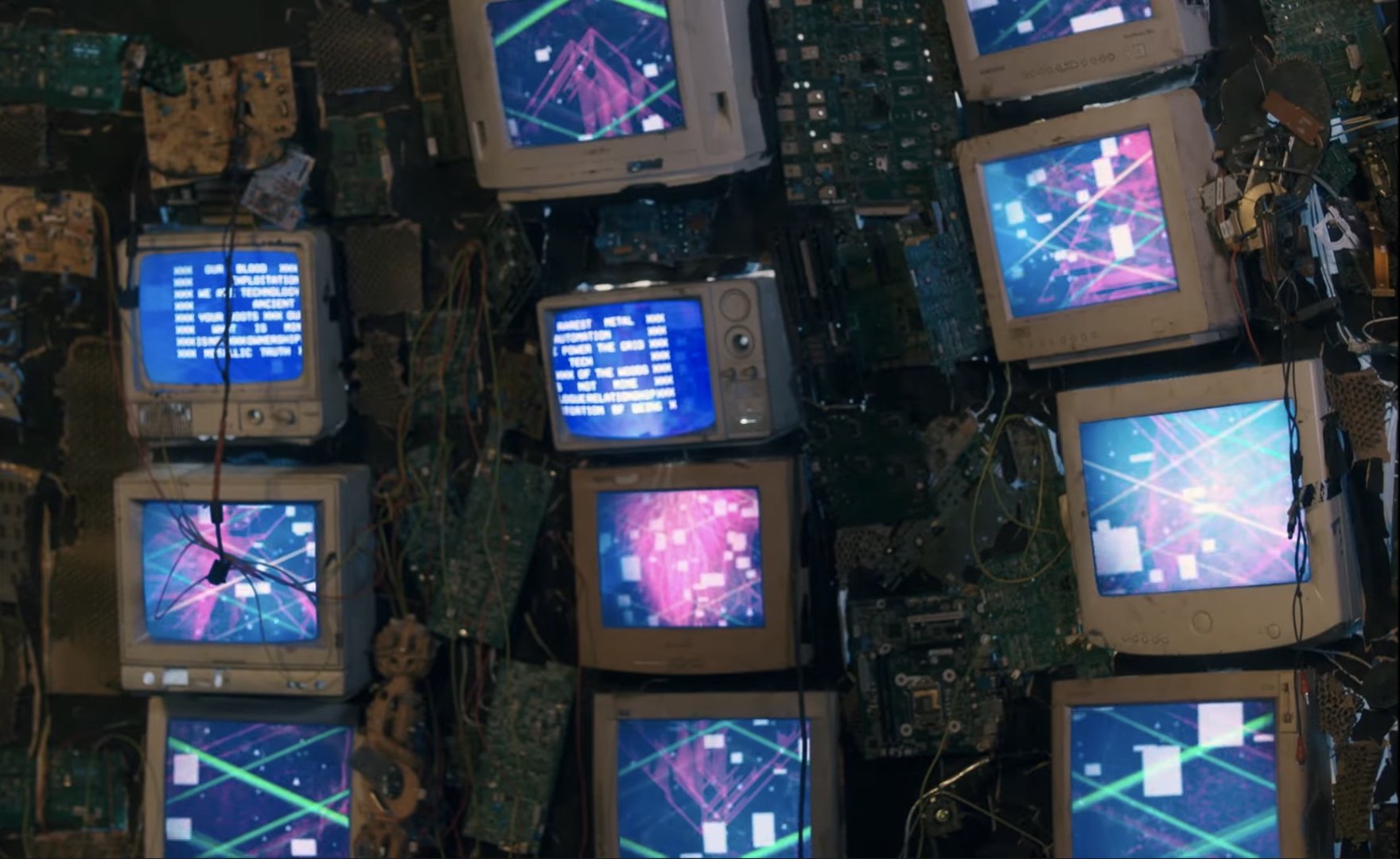 three columns of stacked television sets displaying blue and pink imagery