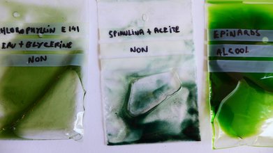 three plastic bags full of green liquid with labels written in sharpie