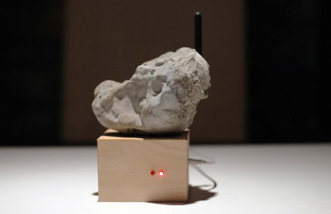 moon rock sitting on a golden box with a red light