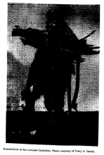 Darkly lit silhouette of man wearing a suit. A snapshot of a shadow snooping through a dark room, moments before anticipated action.