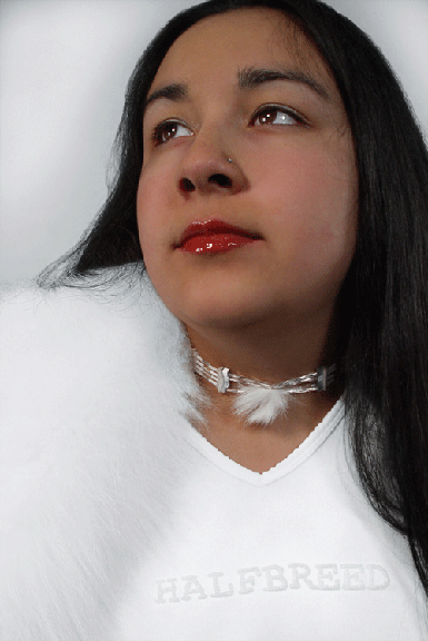 portrait of an indigenous women wearing all white wearing an ornate necklace