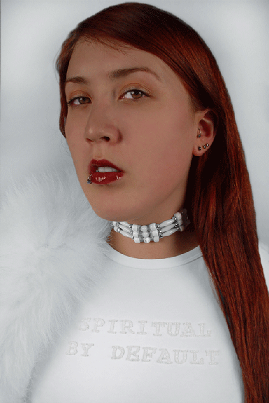 portrait of an indigenous women wearing all white wearing an ornate necklace