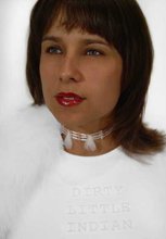 portrait of an indigenous women wearing all white wearing an ornate necklace