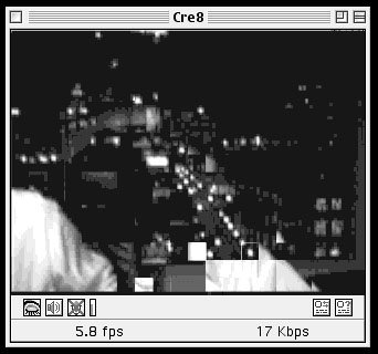 Vintage GUI of a media player showing a low resolution image of a window to a highway and city with bright twinkling lights.