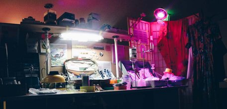 Photo of a desk displaying different lab materials and equipments out of a briefcase on a long desk.