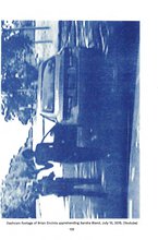 A white page with a sideways blue filtered blurry photo of a policeman wearing a hat standing in front of a person next to an open doored car. Below is a black text caption.