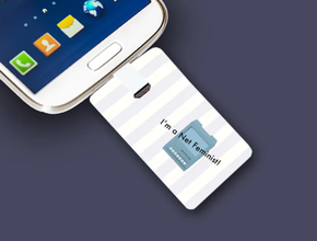 A business card with a USB stick is plugged into a cell phone