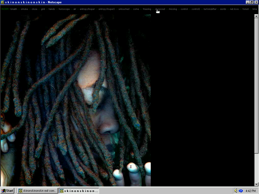 Screenshot of vintage Microsoft webpage with a menu of different words on top. The mouse hovers over the word "obsessed." The window shows a person with black dreadlocked, eyes closed, fingers tapping on a glass surface, side-lit by a green ominous light.