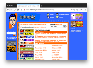 Screenshot of a blue homepage. A blue eyed cartoon figure with short hair sits on the top left and smaller heads on the top right as the site menu. The center is a white page filled with orange text and a directory of cartoon illustrations as a directory.