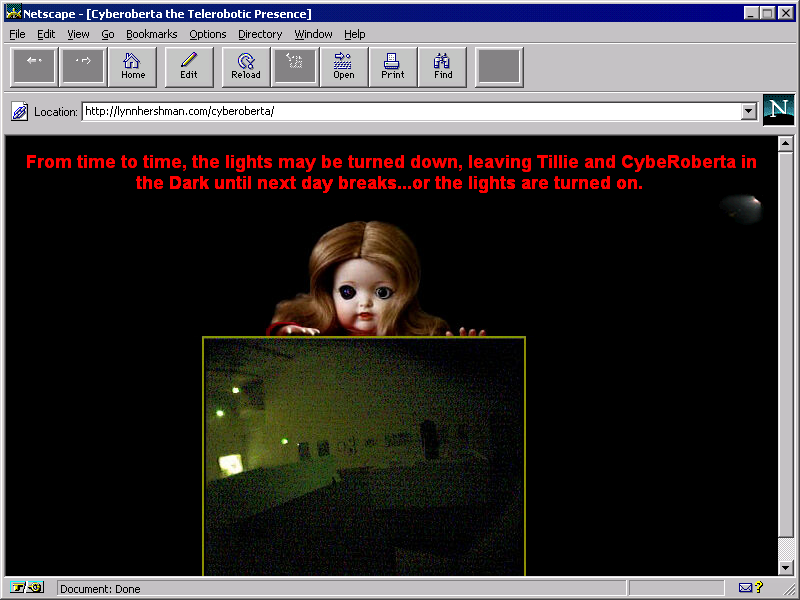 Screenshot of an eerie retro desktop browser with red text and a black background. A human baby doll with a web camera as its right eye creepily peaks its head out of a virtual screen window displaying a surveillanced darkly-lit gallery.