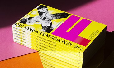 Photo displaying six stacked yellow magazines. The cover has a large "X" filled by a black and white image of flowers with large "F" colored by a pink and red gradient below it. A large blank title flanks the left.